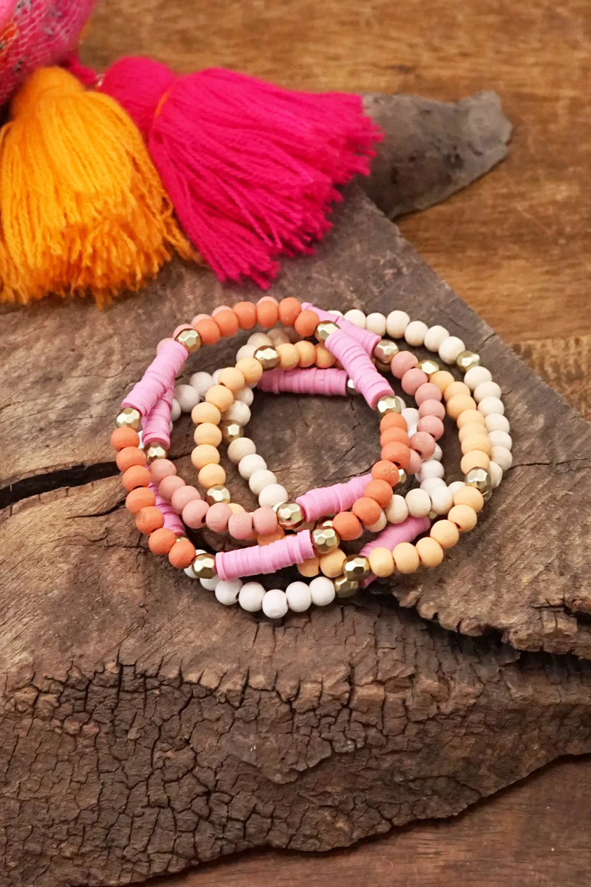 Pink stack of 5 clay and wood beads bracelets in pinks, white and peach